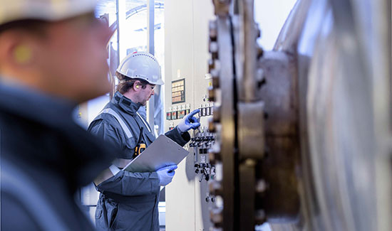 workers inspecting machinery